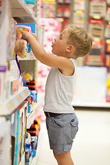 Image showing Boy choosing toy in the shop