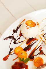 Image showing Vanilla ice cream with sliced kumquats