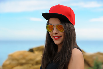 Image showing Young smiling girl in red cap