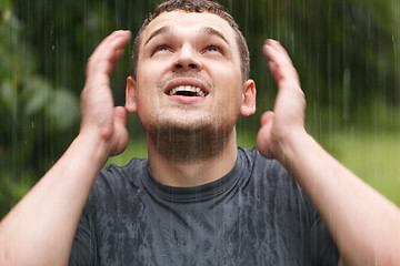 Image showing Young man under the rain.