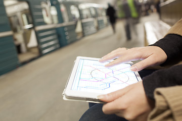 Image showing Woman with pad exploring underground map