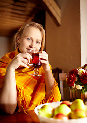 Image showing Young woman is drinking tea.