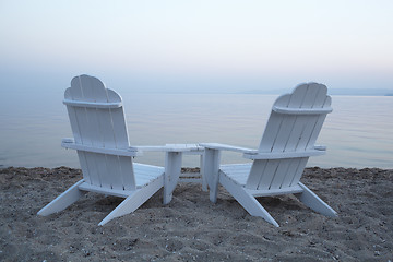 Image showing Empty wooden deck chairs on a beach