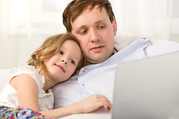 Image showing Father and little daughter using laptop