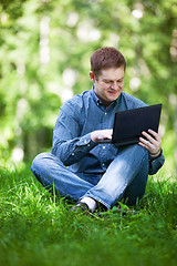 Image showing Businessman working in the city park.