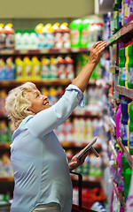 Image showing Woman buying household detergents in the shop