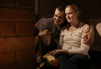 Image showing Loving parents playing with their young son