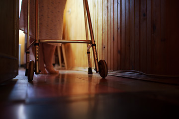 Image showing Senior woman using walker at home