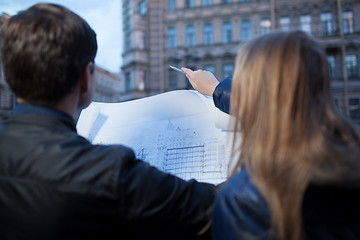 Image showing Man and woman holding blueprint