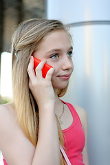 Image showing Young girl talking on the phone outdoor