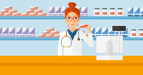 Image showing Pharmacist showing some medicine.