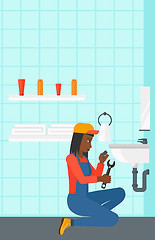 Image showing Woman repairing sink.