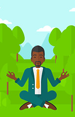 Image showing Businessman meditating in lotus pose.