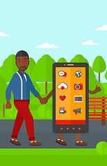 Image showing Man walking with smartphone.