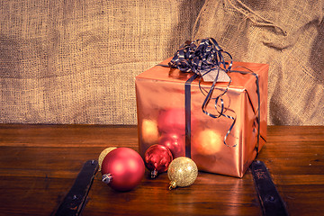 Image showing Shiny Christmas gift on a wooden table