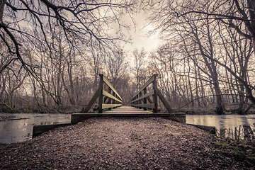 Image showing Wooden bridge over a frozen lake