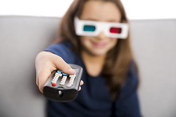 Image showing Girl holding a TV remote