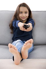 Image showing Girl holding a TV remote