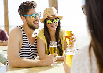 Image showing Friends drinking a cold beer