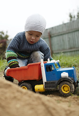 Image showing Boy playing with toy truck outdoor