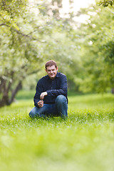 Image showing Middle-aged man resting in the city park