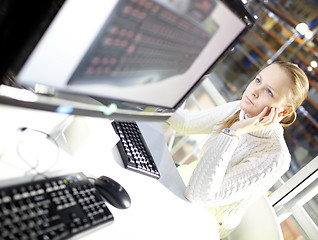 Image showing Young girl is choosing the keyboard.