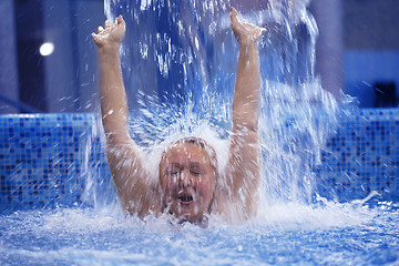 Image showing Woman under water stream in the swimming pool