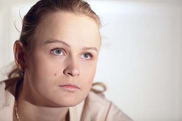 Image showing Young woman is watching an interesting film on tv.