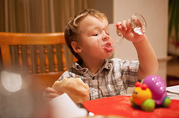 Image showing Young boy enjoying lunch