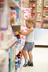 Image showing Boy watching cars in the toy shop