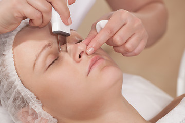 Image showing Face cleaning with ultrasonic equipment at beauty treatment salon