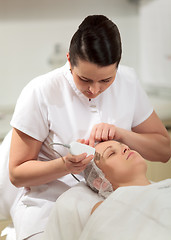 Image showing Cosmetician providing ultrasonic facial cleaning