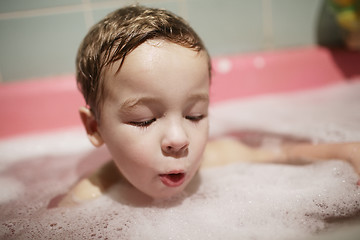 Image showing Little boy enjoying a foamy bubble bath