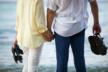 Image showing Couple holding hands at the seaside