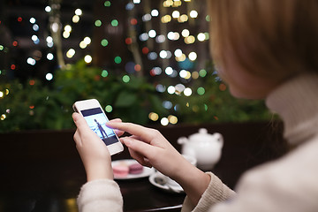 Image showing Woman in cafe with phone