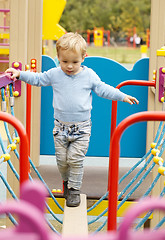 Image showing Cute little boy playing in a playground