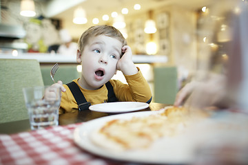 Image showing Young boy yawning as he waits to be fed