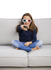 Image showing Girl holding a TV remote