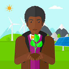 Image showing Man holding plant.