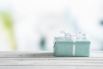 Image showing Blue gift box on a wooden table