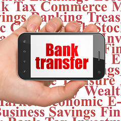 Image showing Money concept: Hand Holding Smartphone with Bank Transfer on display