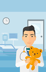 Image showing Pediatrician holding teddy bear.