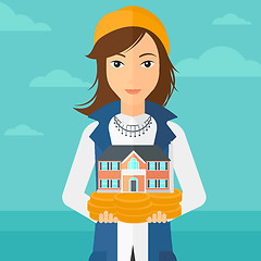 Image showing Woman holding house model.