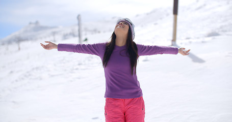 Image showing Happy young woman embracing the winter sun