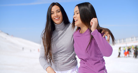 Image showing Laughing vivacious young women at a ski resort