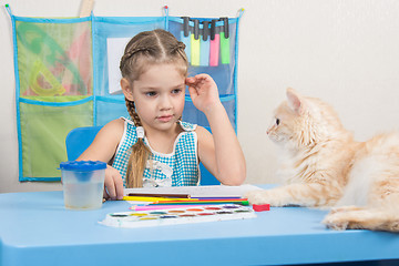 Image showing  Five-year girl drawing pencils looked at the cat