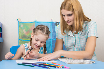 Image showing Girl happily looks at painted with the help of drawing the line