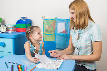 Image showing Five-year girl tutor shows the completed task on a sheet