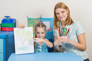 Image showing Five-year girl showing on the picture, my mother keeps in the hands of colored pencils