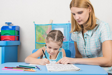 Image showing Tutor helps the child to spell the alphabet